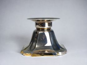 A STERLING SILVER TEALIGHT CANDLESTICK. Wide, weighted tapering base. With remnants of gilding. 7