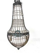 A VICTORIAN METAL DECORATIVE WALL MOUNTED HANGING FLOWER BASKET. Mounted adornments and glass drops.