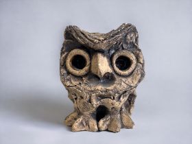 A VINTAGE STUDIO POTTERY OWL FIGURE. Unglazed exterior with glazed eyes. Marked to base. Height -