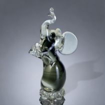 A VINTAGE MURANO GLASS ELEPHANT FIGURE. By Campanella, in smokey grey, sat on his haunches in a