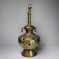 A large Tibetan brass table lamp. 1st half 20th century. With applied Buddha's, animals and