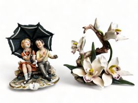 A Capodimonte bisque porcelain figure group, together with a Napoleon porcelain flower group.