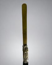 A Japanese brass page turner. Late Meiji / Taisho era. With a figural handle. Length - 30.5cm