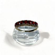 A Vintage 9CT Gold & Garnet Ring. Set with seven round cut garnets. London, 1979 hallmarks. UK