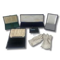 Collection of vintage spoon presentation boxes and a pair of ladies driving gloves.