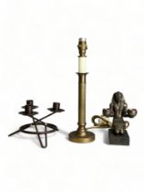 A Brass column lamp with two other decorative candlestick holders.
