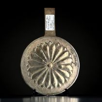 A Japanese bronze hand mirror. Late Meiji period. Signed 'Funisada, first under heaven'. Length -