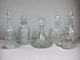 A collection of antique cut glass decanters.