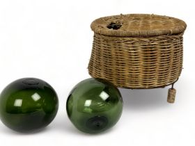 A vintage wicker fishing creel basket, together with two Antique glass fishing floats (witches