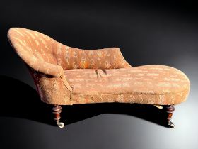 A Victorian Mahogany frame Chaise lounge. Original patterned upholstery, with turned Mahogany legs