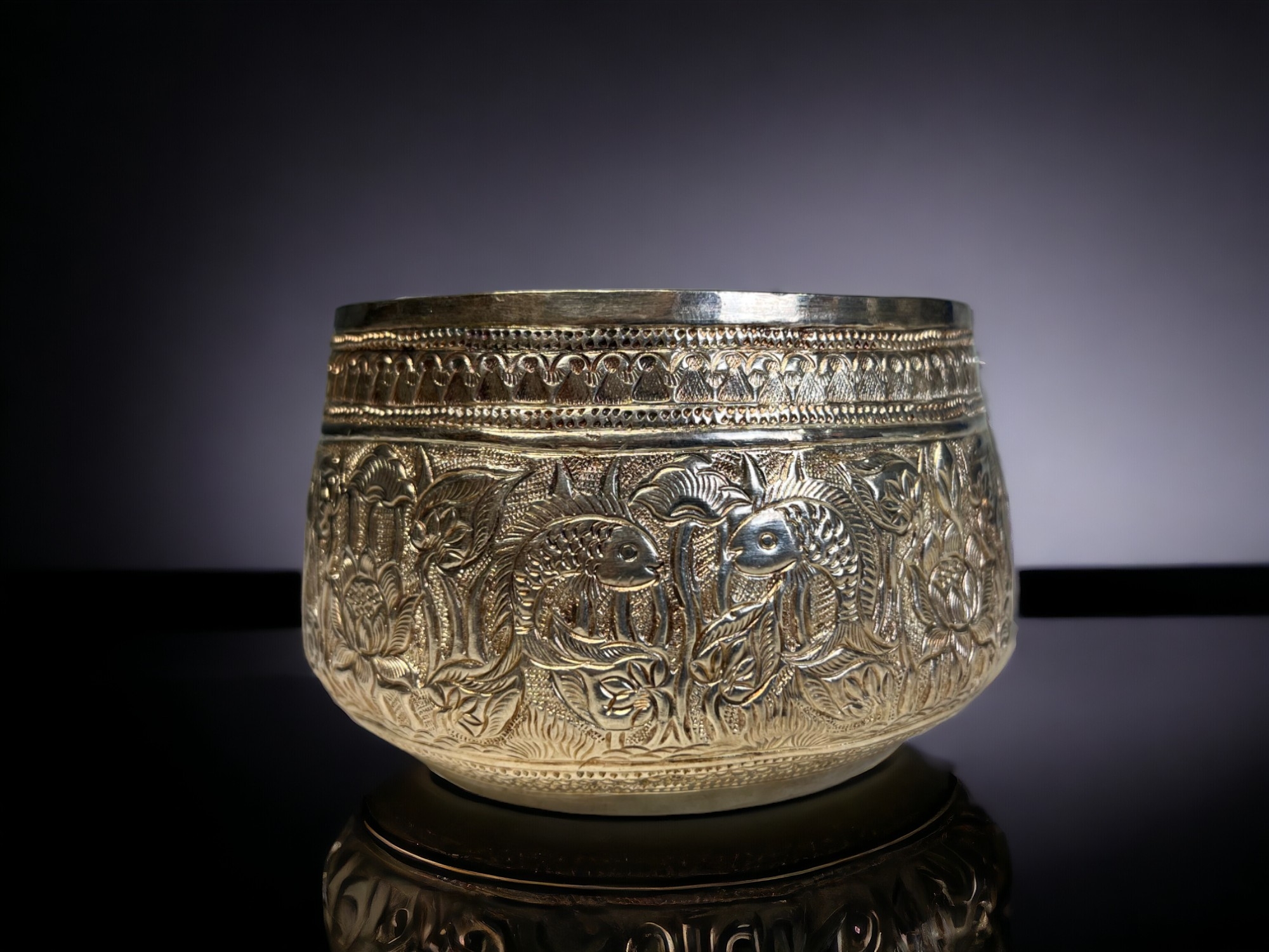 A PAIR OF BURMESE SILVER THABEIK BOWL. Repousse decorated with fish and crabs amongst stylised - Image 2 of 3