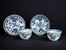 TWO CHINESE BLUE & WHITE PORCELAIN TEABOWLS & SAUCERS. Kangxi period. Painted vases of flowers.