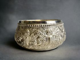 A Burmese Silver 'Thabeik' bowl. Ornately embellished with chased repoussé series of animals.