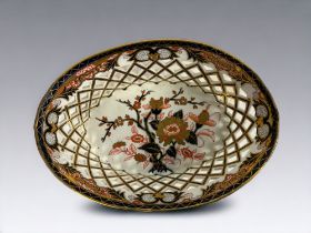 A 19th Century English porcelain 'Imari' chestnut basket. Reticulated sides. Leaf marks to base.