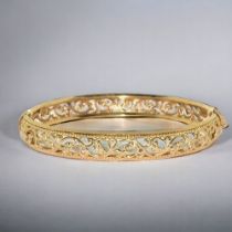 A ladies 9ct gold open work bangle. With spring closed mechanism. Weight - 9.3g