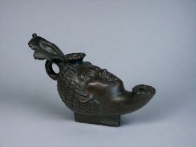 A GRAND TOUR BRONZE 'ROMAN' OIL LAMP. 19th Century. Modelled as a woman's head with elaborate head