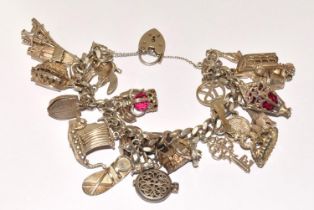 Large silver charm bracelet to include a Disney charm having padlock clasp and safety chain 30+