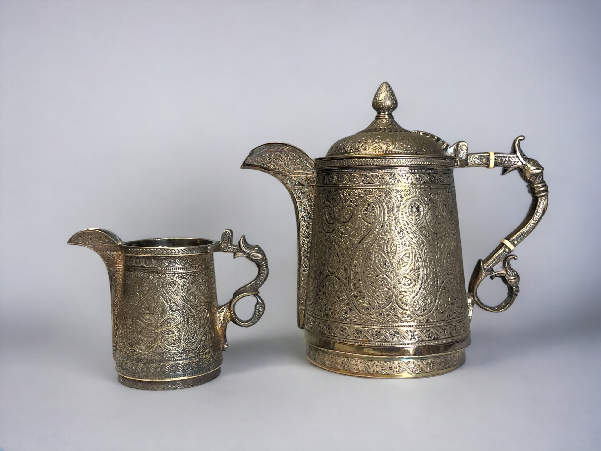 A VICTORIAN SILVER PLATE KASHMIRI STYLE TEAPOT & MILK JUG. By Roberts & Belk. Elaborately