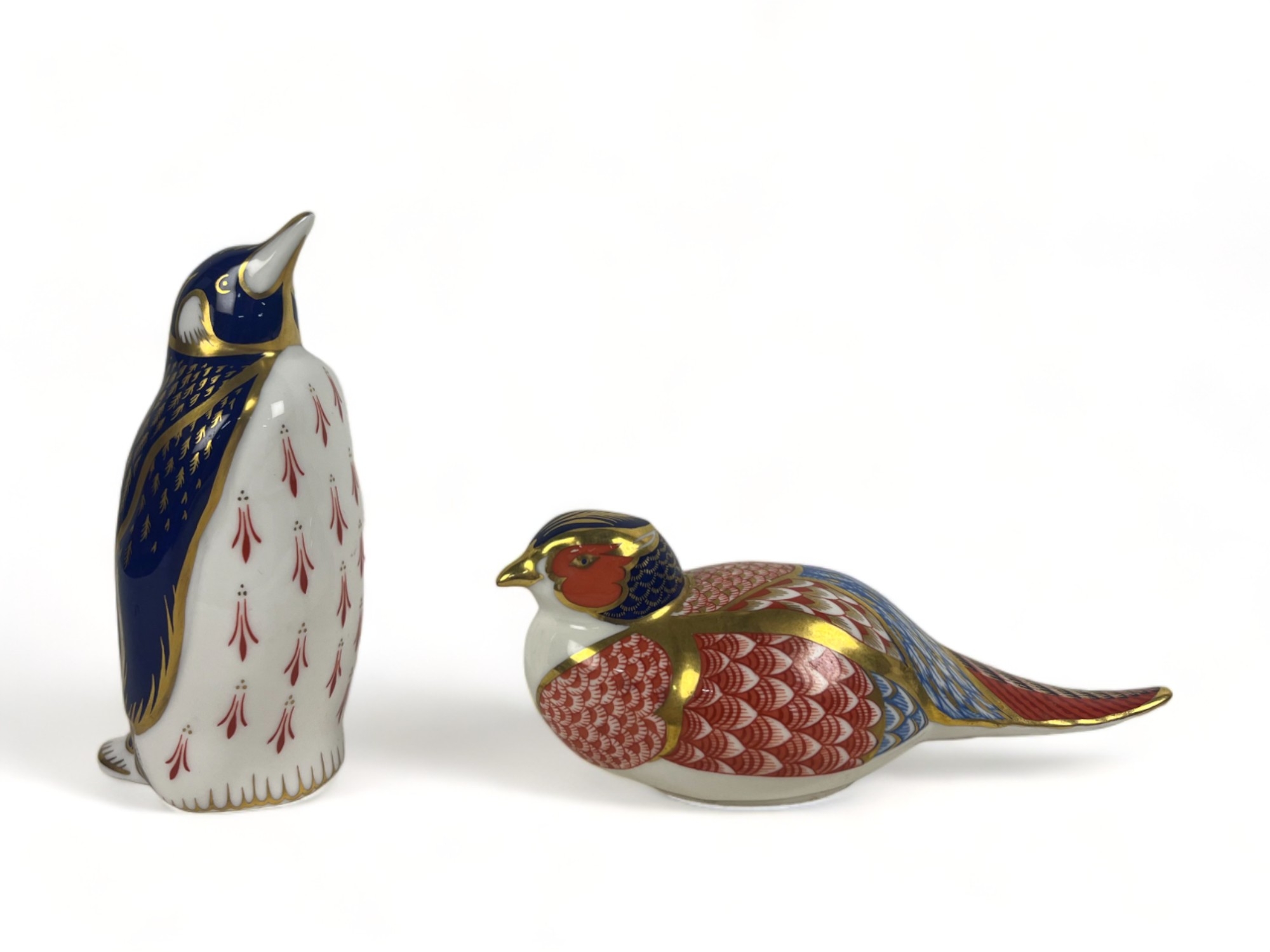 Two Royal Crown Derby paperweights. Including a Pheasant & penguin.