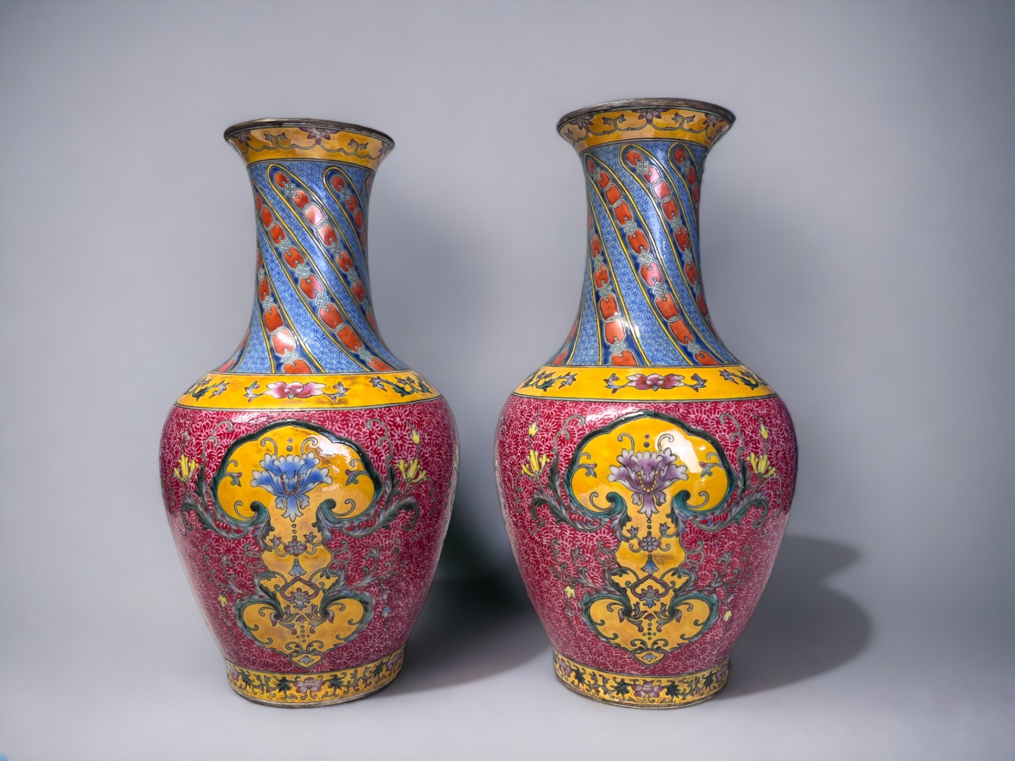 A PAIR OF CHINESE HAND PAINTED PORCELAIN VASES. Baluster form, painted enamels flowers in stylised