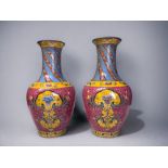 A PAIR OF CHINESE HAND PAINTED PORCELAIN VASES. Baluster form, painted enamels flowers in stylised