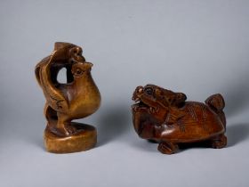 Two carved Japanese Netsuke's. 20th century. One Phoenix, signed to base. Together with a Dragon-