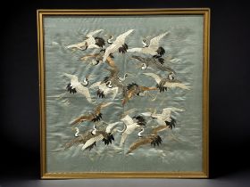 A fine quality Japanese school Silk tapestry panel. Meiji period. Depicting numerous Cranes, on blue