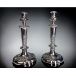 A PAIR OF GEORGIAN SHEFFIELD PLATE CANDLESTICKS. Relief decorated foliate design. Height - 30cm