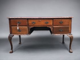 A 20th Century Mahogany Desk, with dragoon edging, cabriole legs with ball and claw feet. Green