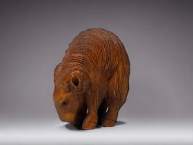 A Japanese carved Netsuke. 20th century. Depicting a Goat, with high arched back. Signed to hind
