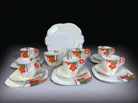 AN ART DECO HAND PAINTED PART TEASET. Hand painted floral pattern with 'flower' handles. Includes,