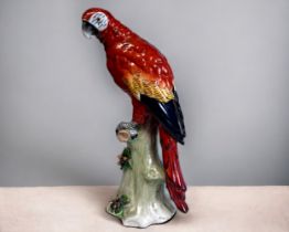 A SITZENDORF PORCELAIN PARROT FIGURINE. 'Scarlet Macaw' Sitzendorf, Thuringia, C1920. Height - 23.