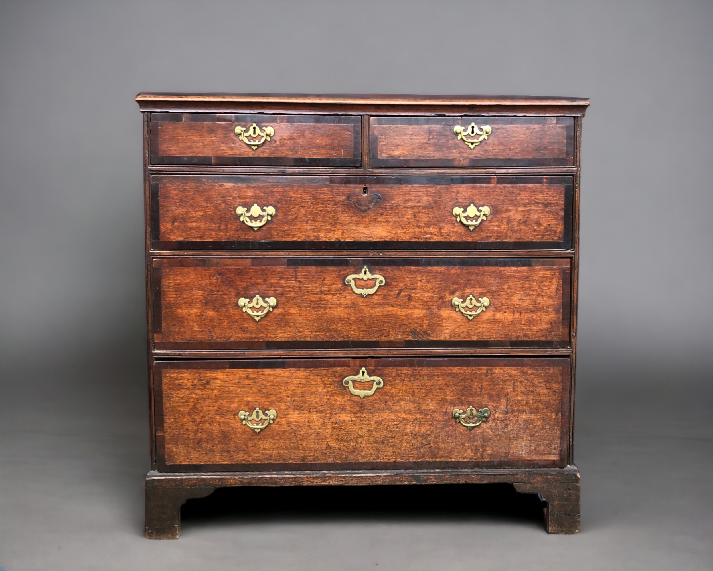 A 19th CENTURY MAHOGANY CHEST OF DRAWERS. Three graduating long drawers below two short, with ornate