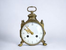 AN ED CHARTIER, PARIS FOR HARRODS 'pendule d'officier' CARRIAGE CLOCK. Gilt, circular form on four