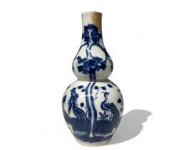 A CHINESE BLUE & WHITE PORCELAIN DOUBLE GOURD VASE. Qing dynasty. Painted with numerous exotic birds