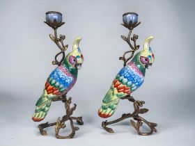 A PAIR OF LARGE HANDPAINTED CERAMIC PARROTS CANDLESTICKS. Gilt metal mounted in a Acorn & leaf