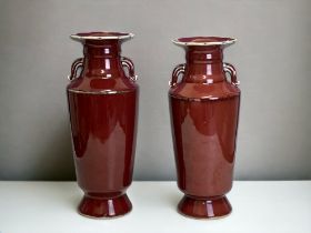 A LARGE PAIR OF CHINESE SANG DE BOEUF PORCELAIN VASES. HIGH SHOULDERED WITH TAPERING NECK AND TWIN