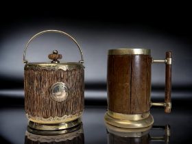 A CHRISTOPHER DRESSER DESIGN TANKARD. By Hukin & Heath, Oak lined and handle. Together with an Oak