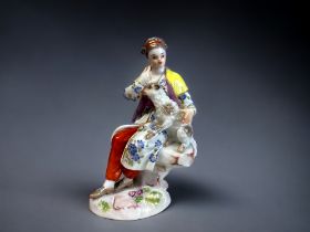 A MEISSEN PORCELAIN 'SHEPHERDESS' FIGURINE. Depicting a Shepherdess? seated on a rock with a Lamb.