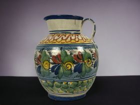 A large Continental Maiolica jug. 18th / 19th century. Hand painted foliate design. Unmarked. Height