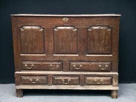 A 17TH CENTURY JACOBEAN OAK PANELLED MULE CHEST. lift-lid revealing large storage space, above two