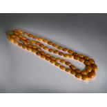 Baltic 'Butterscotch' Amber double row necklace. Graduating beads, with gilt metal clasp.