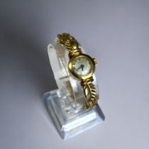 18CT GOLD LADIES ROLEX COCTAIL WATCH. Circa 1958. With unusual 18ct gold 'leaf' design strap.