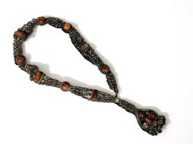 A LARGE TIBETAN HAND MADE NECKLACE. Metal, inlaid with large polished cabochon stones.