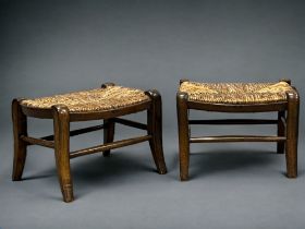 A pair of 19th century provincial fruitwood footstools. On sabre legs linked by stretchers, with