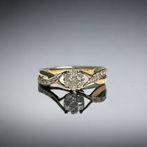 A 9ct gold 25pt Diamond cluster ring. Accented with further diamonds to shoulders. Hallmarked. Size