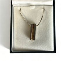 A silver & yellow metal bar necklace. Stamped "TMH" & "925". With original silver chain.