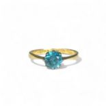 A 10ct white & yellow Gold ladies solitaire ring. Set with a solitaire blue stone.  Size 0 1/2 