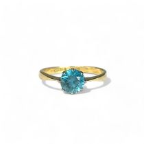 A 10ct white & yellow Gold ladies solitaire ring. Set with a solitaire blue stone. Size 0 1/2