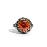 A silver, Marcasite and orange stone set ladies ring. Stamped S925. 